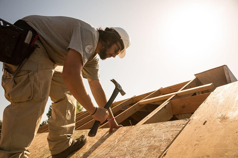 Young man working on a house